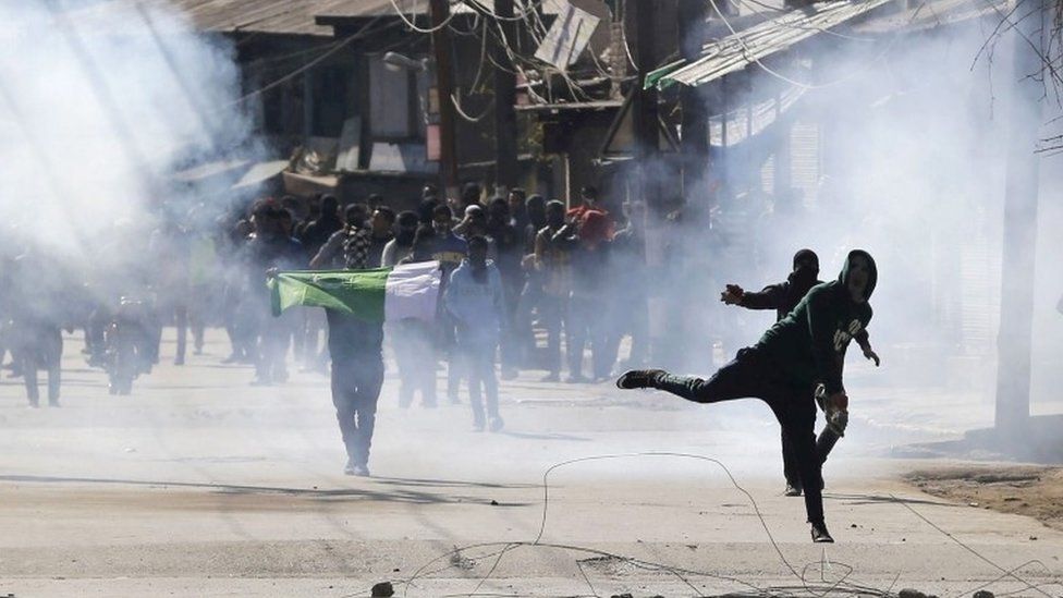 Kashmiri Muslim protestors throw stones at Indian police and paramilitary soldiers amid tear gas during clashes in the downtown area of Srinagar, the summer capital of Indian Kashmir, 26 February 2016.