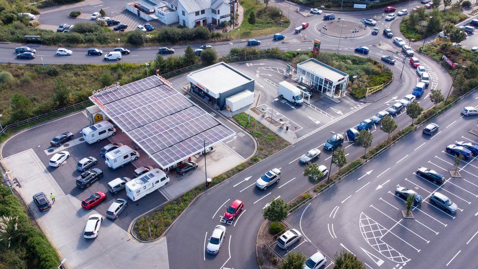 Vehicles queue for fuel at a Sainsbury's petrol station in Weymouth, England