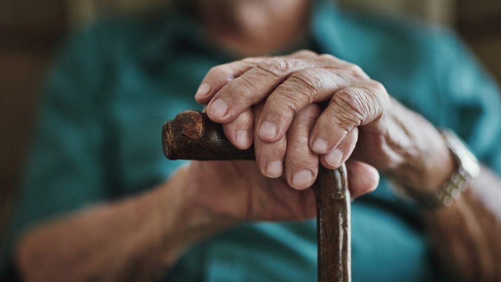 Elderly person with stick
