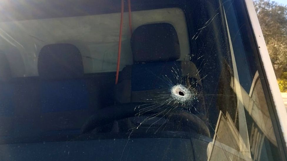 Bullet hole in the windscreen of the family's van