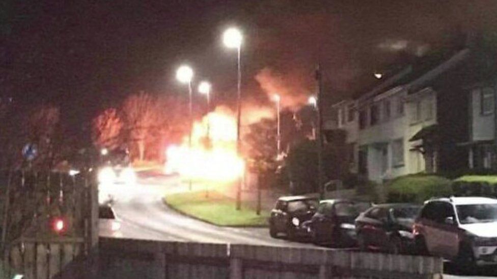Bins were set alight and used as a burning barricade during trouble in Larne