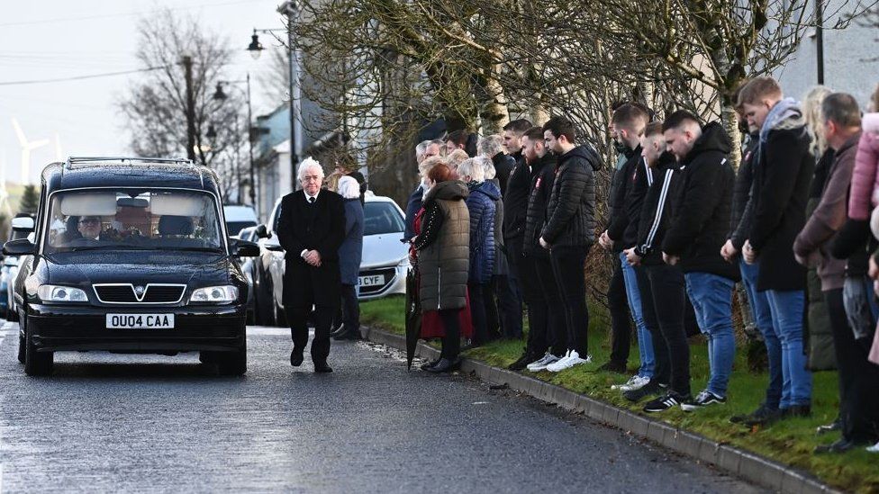 Mourners line the route of Peter McNamee's funeral on Saturday