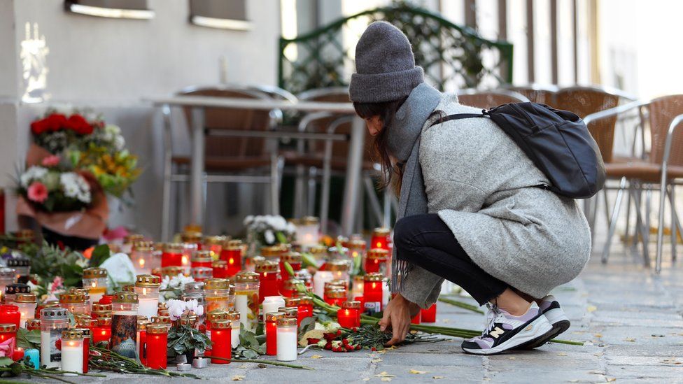 A woman places flowers at the site of a gun attack in Vienna, Austria, November 5, 2020