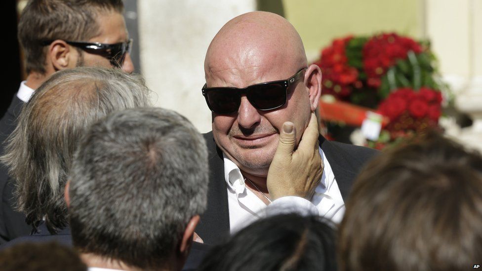 Philippe Bianchi, the father of French Formula One driver Jules Bianchi, is comforted by a relative prior to the funeral of his son at Sainte Reparate Cathedral in Nice, French Riviera, Tuesday, July 21, 2015