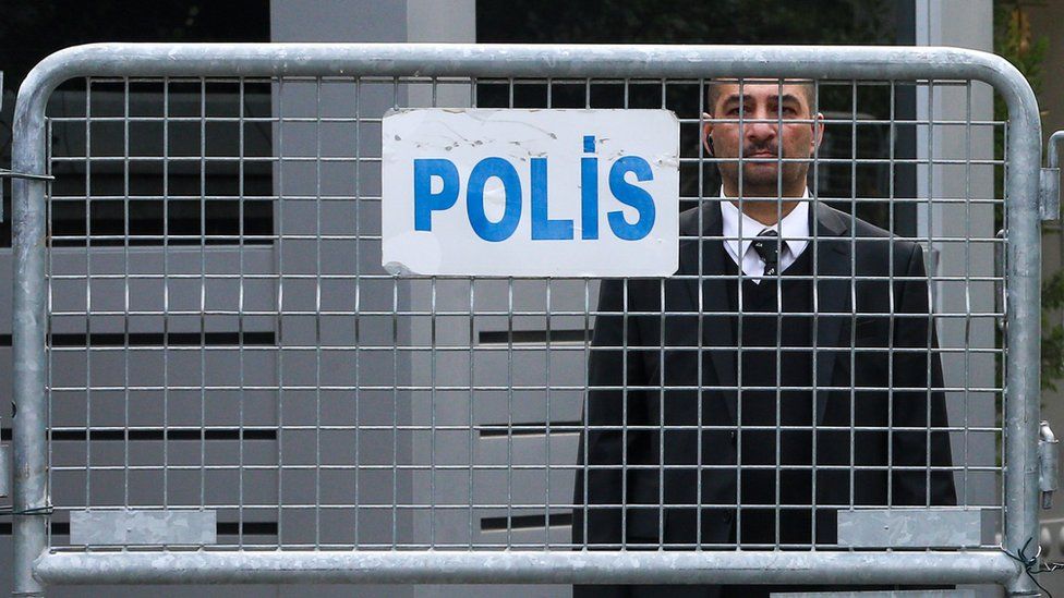 An official stands behind police barriers at the Saudi consulate in Istanbul, Turkey, 21 October 2018