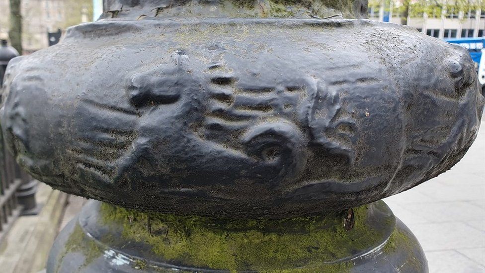 Lamppost at city hall with seahorses engraved on the post