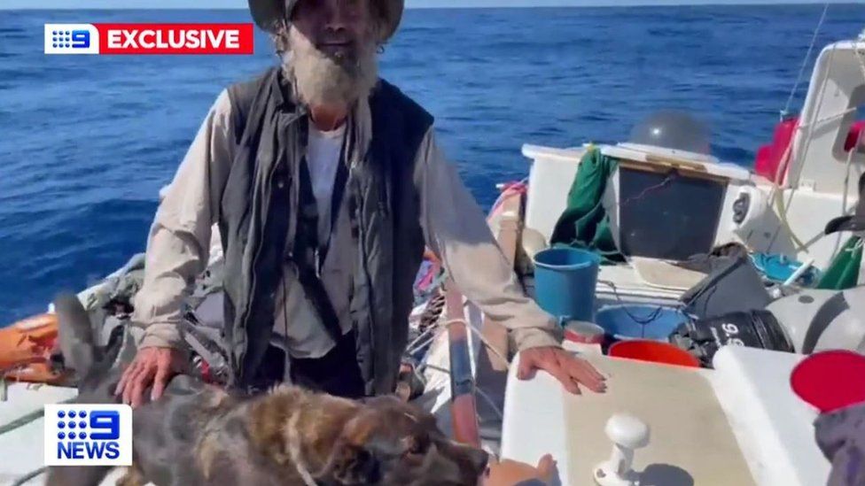 Timothy Shaddock and his dog on their boat