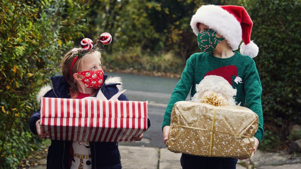 children holding Christmas gifts