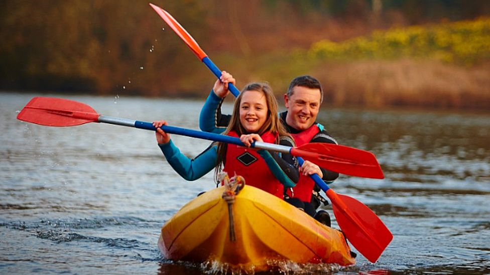 Man and kid  kayaking