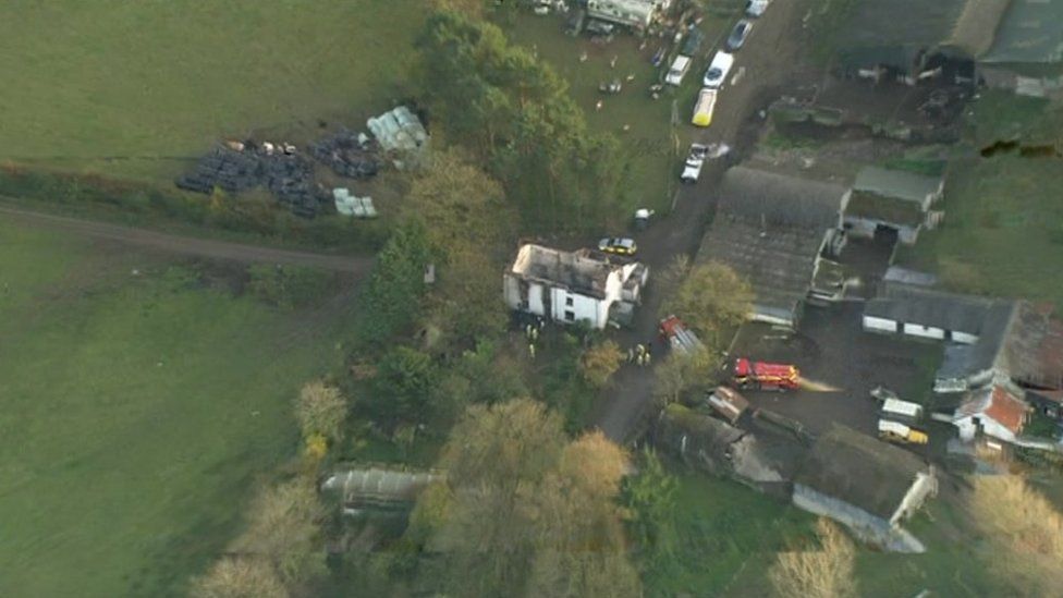 The scene of the house fire in and emergency service vehicles in Llangammarch Wells