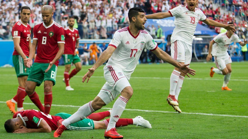 Iranian players celebrate after Morocco's Aziz Bouhaddouz scores an own goal in the 2018 World Cup