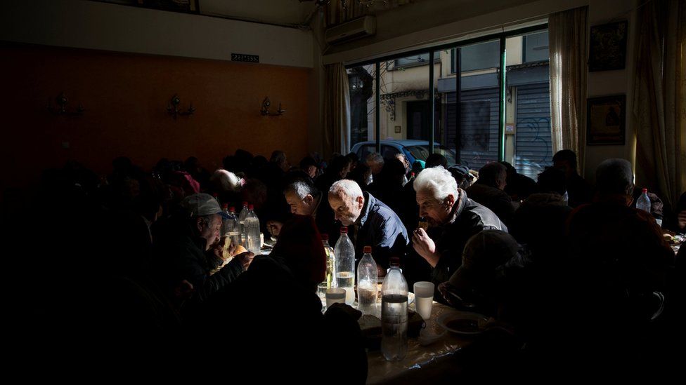 People eat at a soup kitchen run by the Orthodox church in Athens, Greece, February 15, 2017