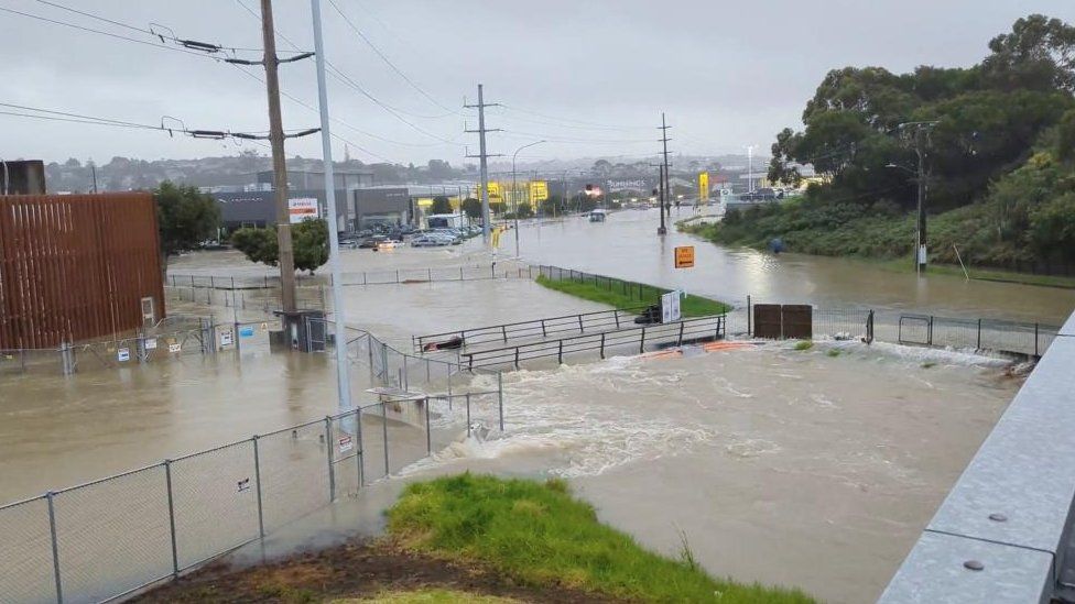 An area flooded during heavy rainfall is seen in Auckland, New Zealand January 27, 2023, in this screen grab obtained from a social media video.