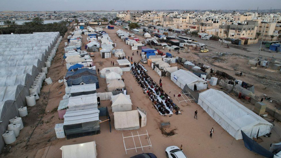 Palestinians, who were displaced by Israel's military offensive, gathering to have their Iftar (breaking of the fast) during the holy month of Ramadan, in Rafah in the southern Gaza Strip April 6, 2024.