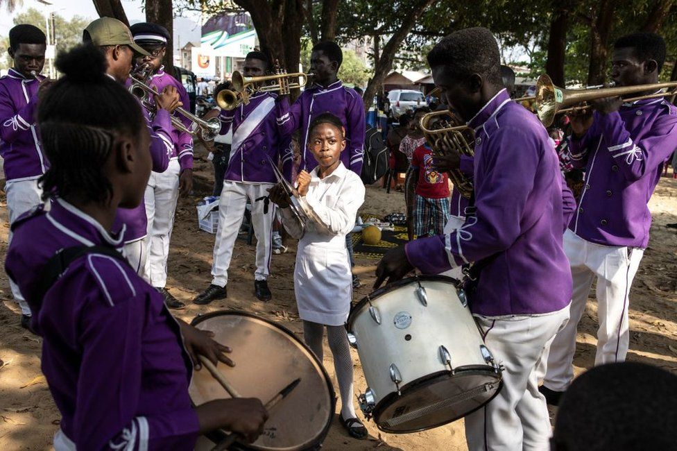 Members of the Area 10 Scout brass band play along Lumley beach in Freetown. Brass bands have a long history in Sierra Leone and are slowly making a come back after the war. Most neighbourhoods, scout groups and schools have a brass marching band and competitions are held regularly. Bands spend hours training, promoting and recruiting more players by playing on public holidays and at events.