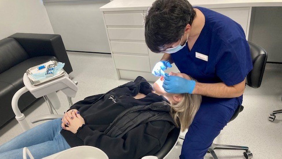 A patient being treated in the dental clinic