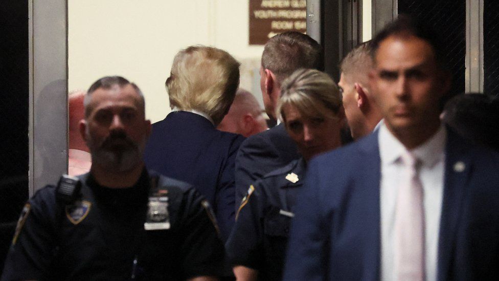 Donald Trump seen from behind as he leaves court