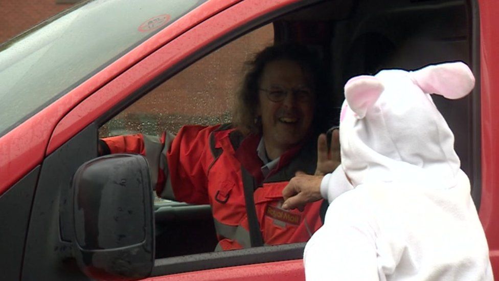 Maria Draper speaking to a postman through his van window