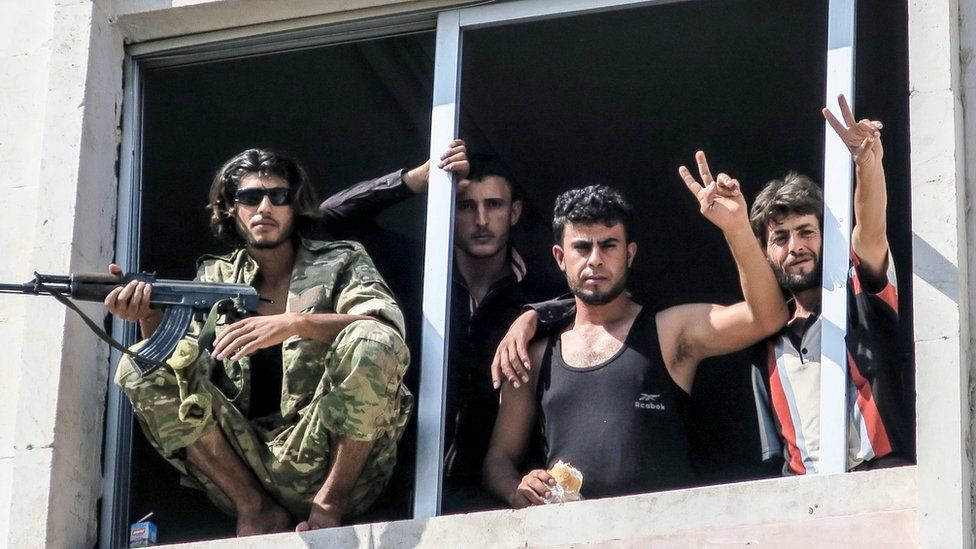 Free Syrian Army fighters gesture in Jarablus, Syria, Wednesday, Aug. 31, 2016.