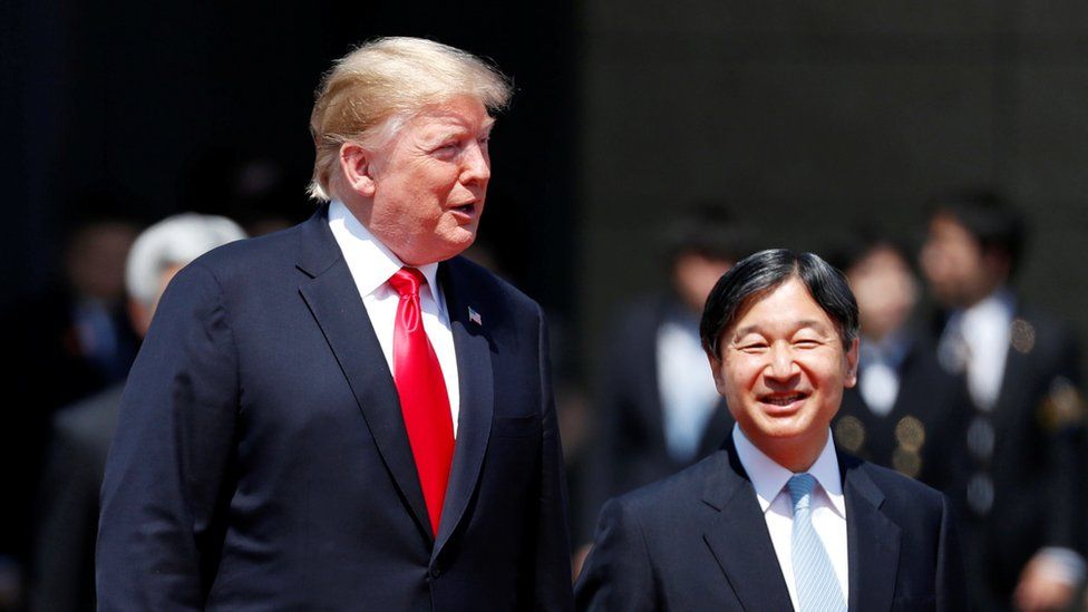 U.S. President Donald Trump is escorted by Japan"s Emperor Naruhito during an welcome ceremony at the Imperial Palace in Tokyo, Japan
