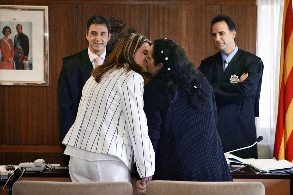 Veronica kisses Tiana in front of the municipal councellor Jorge Vergara (left) during their wedding, at Mollet del Valles near Barcelona, 22 July 2005.