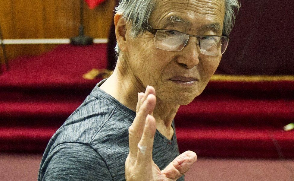 Peru's ex-President Alberto Fujimori gestures before the reading of the verdict on charges of embezzling state funds and using them to manipulate the media, at a police base in Lima, 8 January 2015