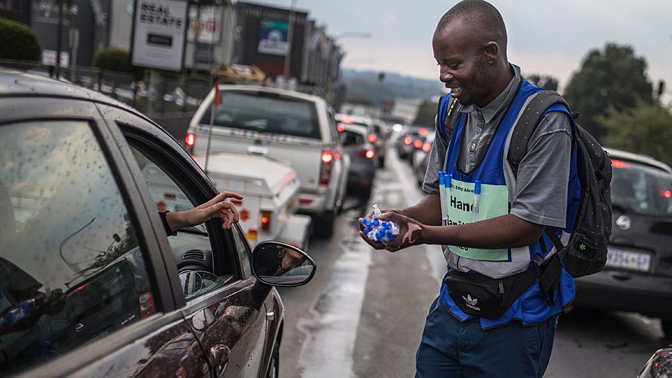 A man sells hand sanitising gel to a motorist in Johannesburg, South Africa - Wednesday 11 March 2020