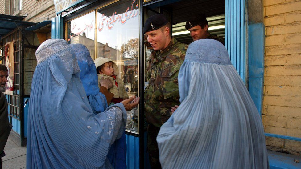 British soldiers encounter a group of Afghan women begging in Chicken Street in 2002
