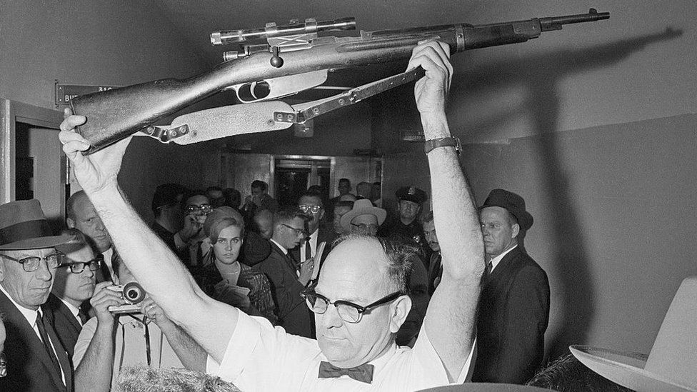 A Dallas policeman holds up the rifle used to kill President John F Kennedy on November 22, 1963. Lee Harvey Oswald has been charged with the murder.