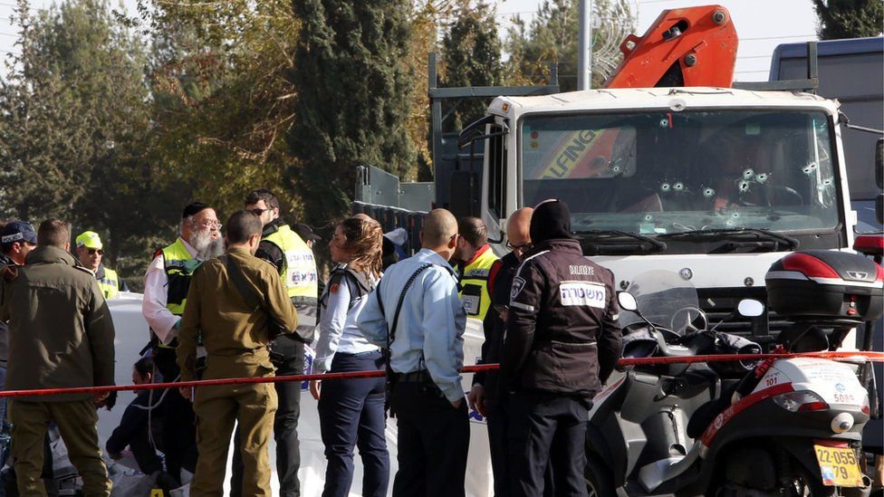 Israeli security forces and medics gather at the site of a ramming attack in Jerusalem on January 8, 2017