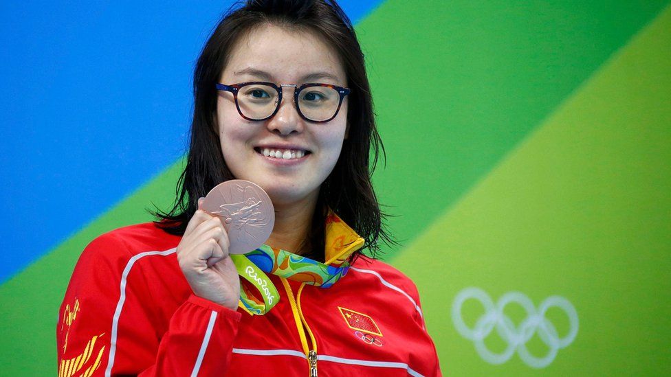 Fu Yuanhui (CHN) of China (PRC) pose with her medal in the Women"s 100m Backstroke Victory Ceremony