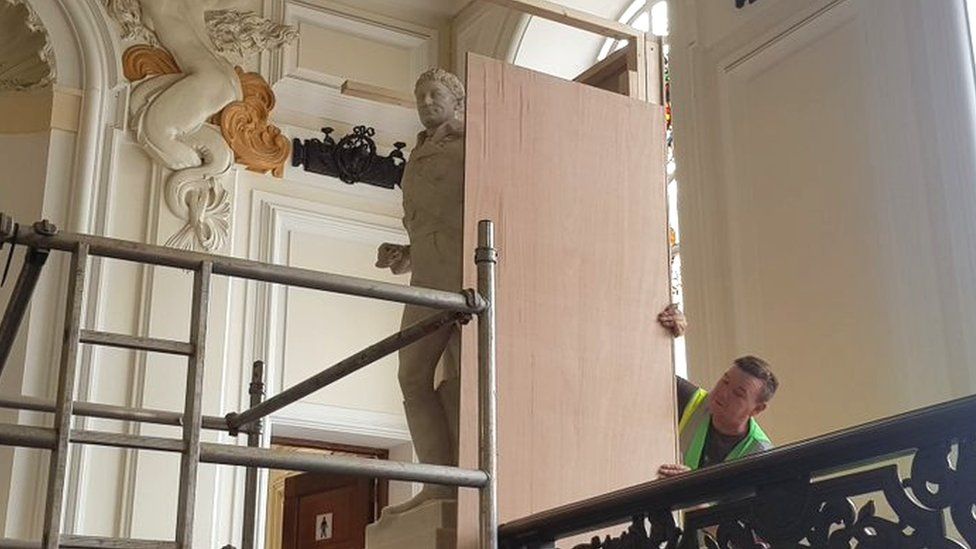 Workman boxing off Sir Thomas Picton statue at Cardiff City Hall