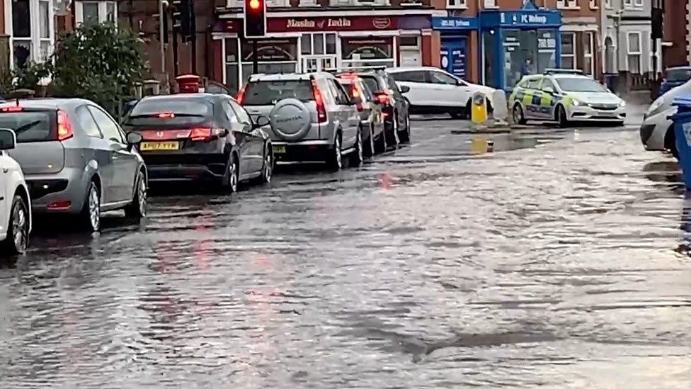 Drains overflowed and manhole covers were lifted along the road near a town centre