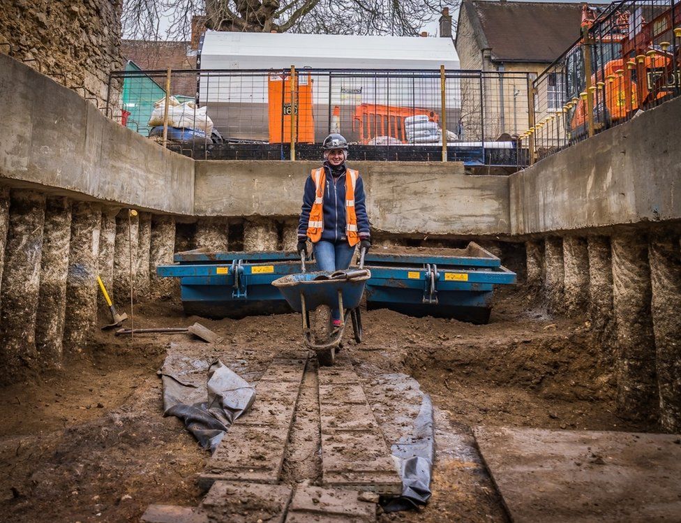 Charlotte Bishop of Oxford Archaeology barrowing excavated spoil in the west wing of the new basement
