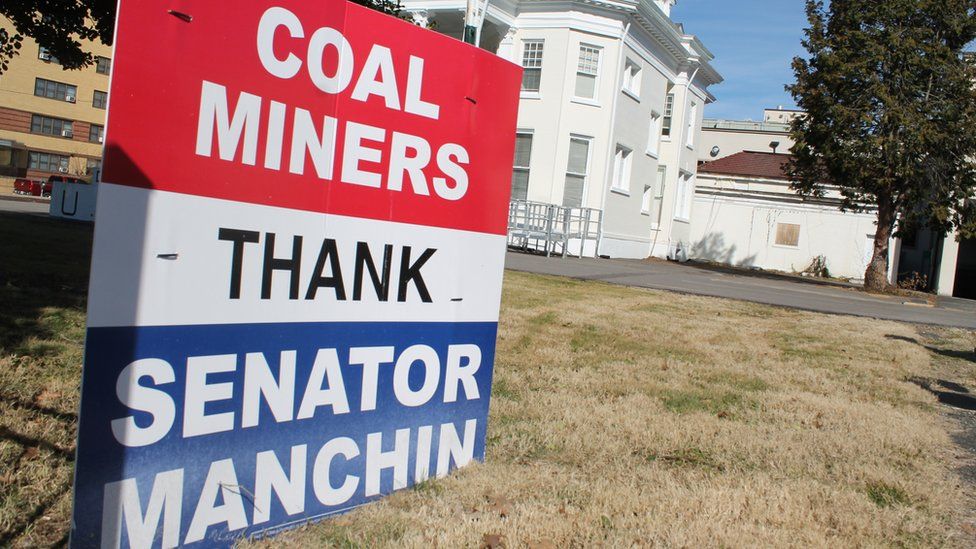 A sign reads Coal Miners Thank Senator Manchin
