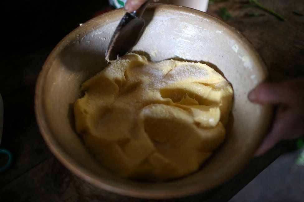 A bowl of butter being stirred