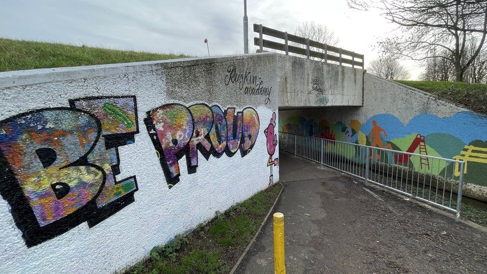 An underpass in Queensway tagged with graffiti saying "be proud"