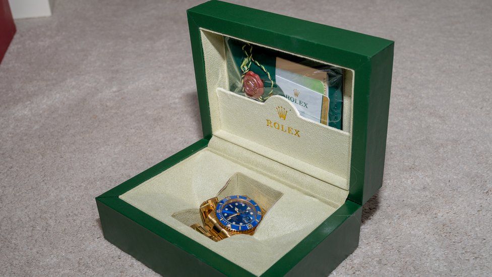 A Rolex watch in a green box
