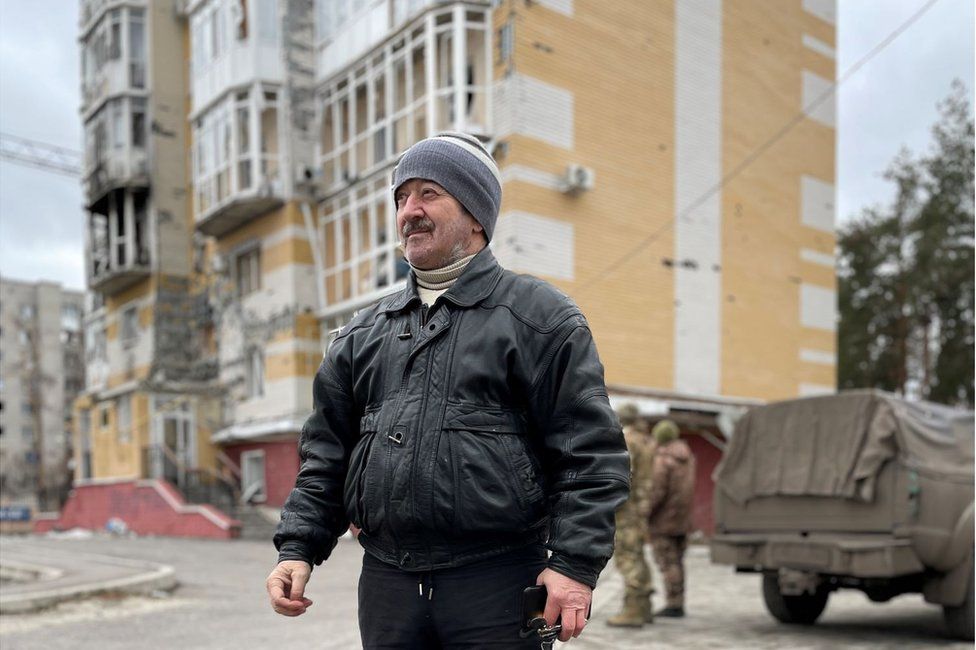 Oleskandr Rogovitz outside his bombed-out block of flats in Lyman