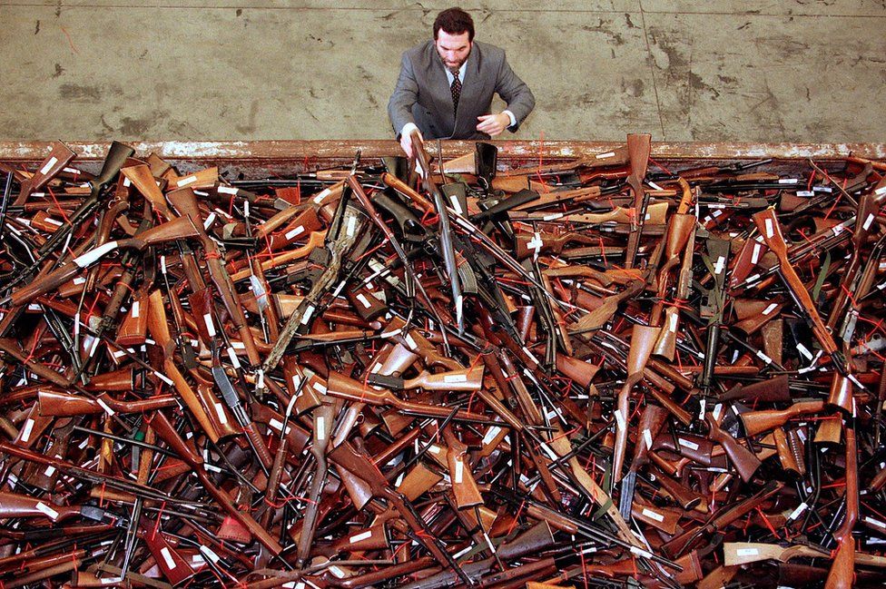 Mick Roelandts, firearms reform project manager for the New South Wales Police, looks at a pile of around 4,500 prohibited firearms that have been handed in under the Australian government's buy-back scheme in Sydney, Australia. 16 June 2017