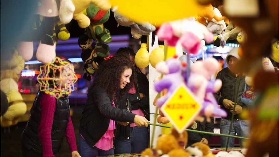 People playing at a fairground stall