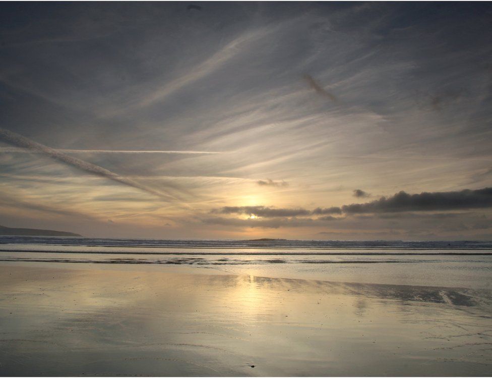 Sunset mirrored on a beach