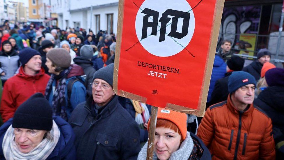 A placard reads, "deport AFD now", during nationwide protests against racism and plans of Germany's far-right Alternative for Germany (AFD) party to deport foreigners, in Bonn, Germany, January 21, 2024