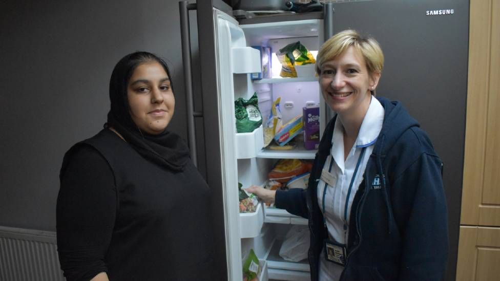 Bradford paediatric dietitian Alison Woodhead helping to clear junk food from a fridge with Maryam, 14