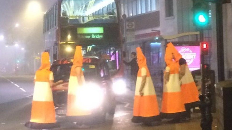 Men dressed as traffic cones