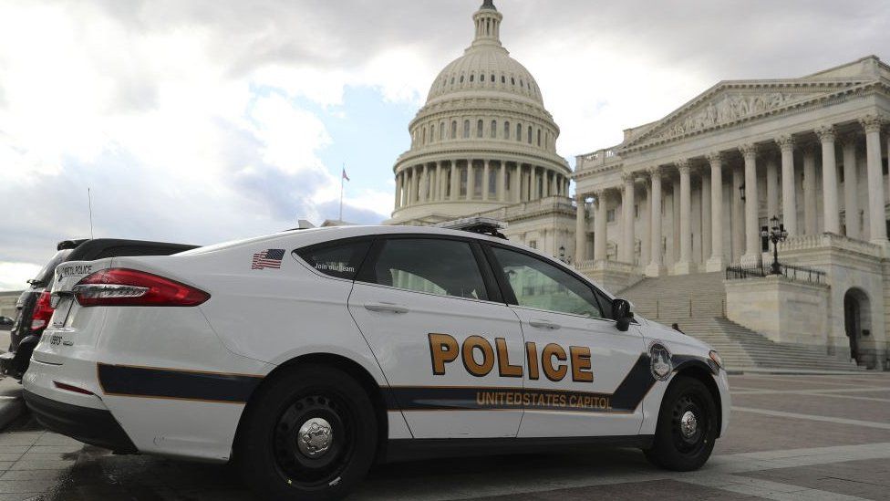 Police car sits outside the US Capitol building in Washington, DC