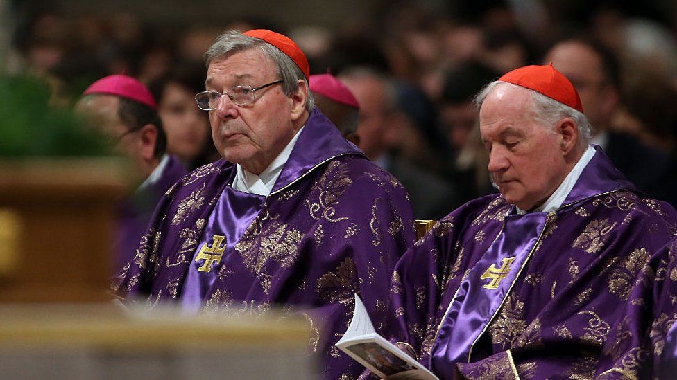 Cardinal George Pell (l) listens to a mass, while sitting among other cardinals at St Peter's Basilica on February 10, 2016 in Vatican City