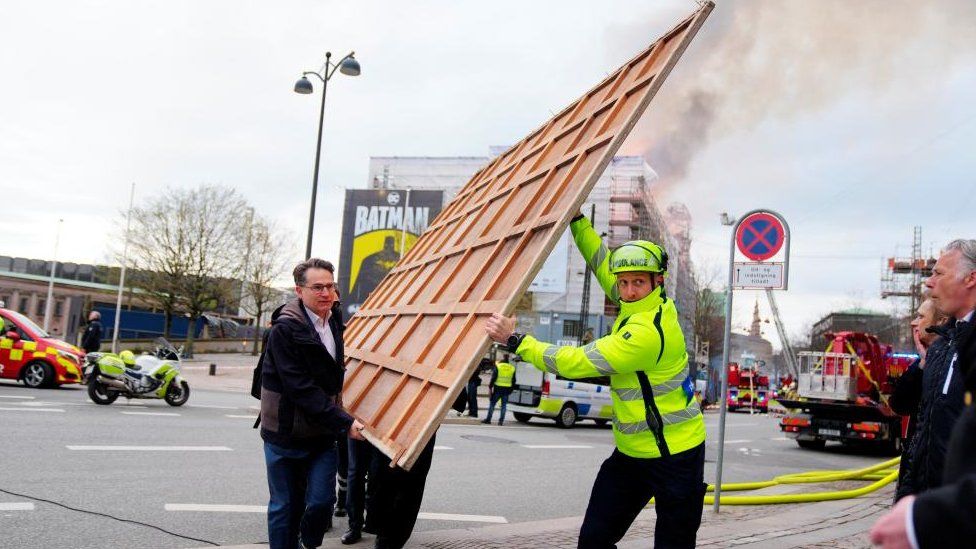 Danish chamber of commerce director Brian Mikkelsen joined ambulance workers in rescuing the building's art treasures