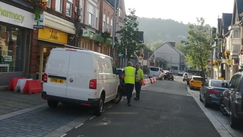 Council workers removing plastic barriers from Herbert Street, Pontardawe