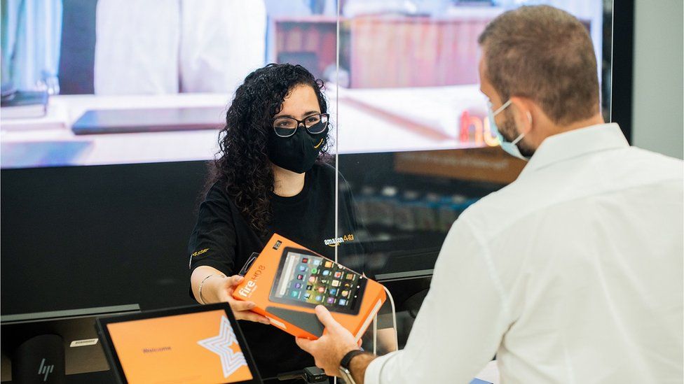 Amazon worker serves a customer